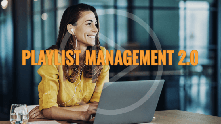 Playlist Management 2.0, Woman smiling as she works on her laptop.