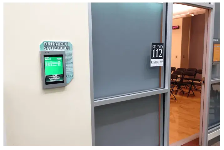 iPad digital signage screens displaying daily rec schedules for rooms at CSU